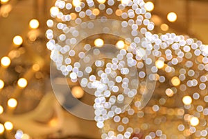the close-up of lighting decoration, blurred lighting in gold and white color.