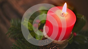 Close up lighting red Christmas candle on wooden table