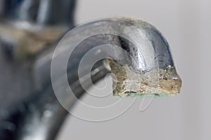 Close-up of limescale build-up. Selective focus on hard water deposit photo