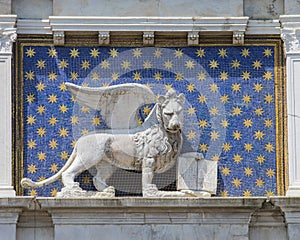 Lion of St. Mark on the Exterior of St. Marks Clock Tower in Venice photo