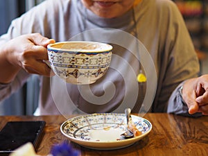 Close-up of the lips of a girl drinking coffee