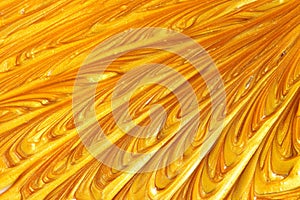 Gold metallic glitter paint swirls