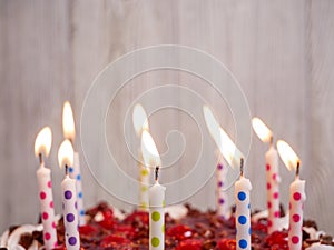 Close up of lit candles on top of a cake