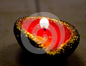 Close up of a lit oil lamp diya during Diwali celebrations in India. Diwali is one of the biggest Indian festivals celebrated ev