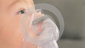Close up of little baby boy is treated respiratory problem with vapor nebulizer to relief cough symptom in the hospital