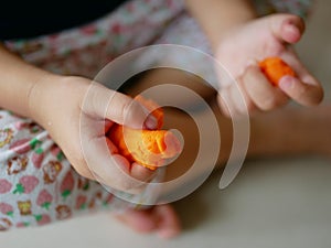 Close up of little baby`s hands playing playdough