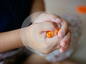 Close up of little baby`s hands squeezing playdough