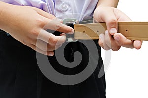 Close-up little boy tightening his belt isolate