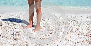 Close up of a little girl feet on tropical sandy