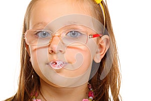 Close up little girl in glasses doing fun saliva bubbles