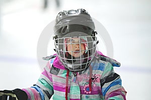 Close up of little girl in a hockey helmet