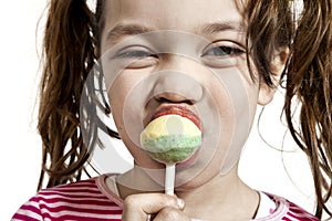 Close-up of little girl with a lollipop