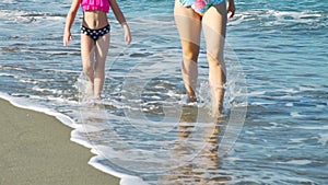 Close Up of Little Girl with Mom Walking on Beach