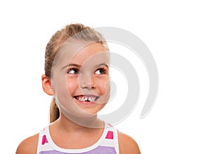 Close up of little girl's face looking aside and smiling
