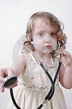 Close-up of a little girl with a stethoscope