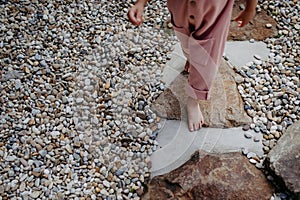 Close up of little girl walking barefoot near the forest cotage,weekend time during summer day.