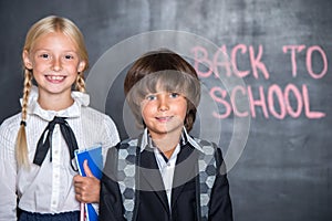 Close-up of little school boy and girl near