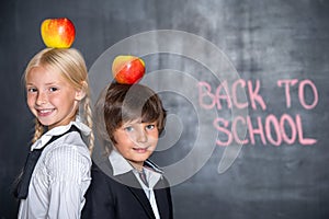 Close-up of little school boy and girl near