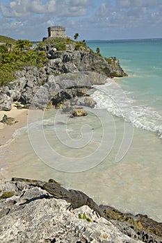 Close-up on Lizard with background of Templo del Dios del Viento Mayan ruins of Ruinas de Tulum (Tulum Ruins) in Quintana Roo