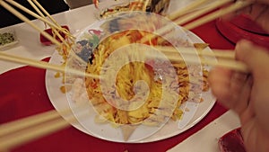 Close up of lo hei, or the Prosperity toss of a dish of Cantonese-style raw fish salad during Chinese New Year celebration. Family