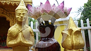 Close up of local spirit house in Southeast Asia; camera starts on gold figur