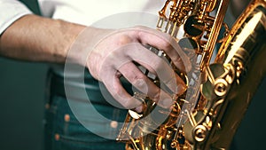 Close up locked down shot of jazz musician playing saxophone in studio.