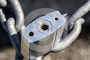 Close up of a locked padlock with silver chain in a Y shape