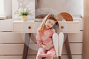 Close up lonely little girl in bedroom with toys, stay at home alone, upset unhappy child waiting for parents