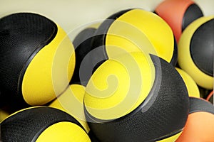 Close-up of a lot of black and yellow sports balls