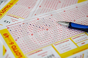 Close-up of lottery tickets and pen on the table