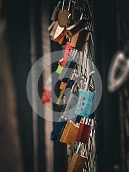 Close up of lovelocks hanging on bridge