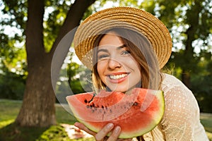 Close up of lovely young girl in summer hat spending time at the park,