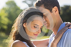 Close-up of loving couple embracing in park