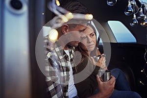 Close up loving couple embracing and sitting in car