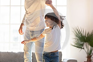 Close up loving father and little daughter dancing at home
