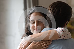 Close up loving wife hugging husband, enjoying tender moment