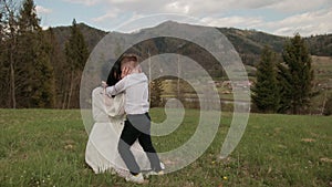 Close-up loving young mother hugging, calming little son who is crying outdoors