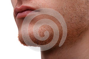 Close-up of the lower part of a man`s face. Isolated over white background