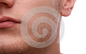 Close-up of the lower part of a man`s face. Isolated over white background