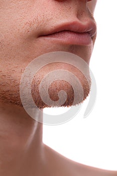 Close-up of the lower part of a man`s face. Isolated over white background