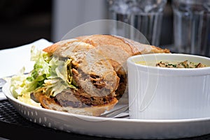 Close-up lunch combo with sandwich and soup.