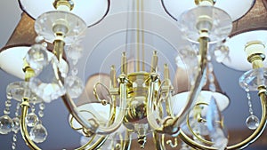 Close-up luxurious chandelier in hotel room or wealthy house indoors. Deluxe interior light fixture. Luxury and design