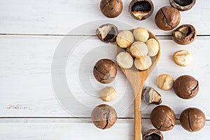 Close up a Macadamia nuts on white wooden background , superfoo