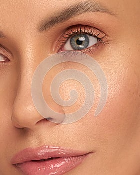 Close-up macro of a beautiful female eye with a perfect eyebrow shape. Clean skin, trendy natural makeup. Good vision