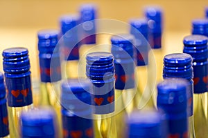 Close up / macro of bottles with blue cap containing a yellow liquid