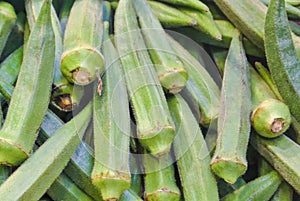 Close up macro of fresh green okra for sale on open street city