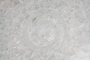 A close up macro photograph of white quartz or granite stone background texture with copy space