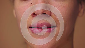 Close up macro portrait of African American woman licking her lips with tongue and biting her lower lip with teeth. Face