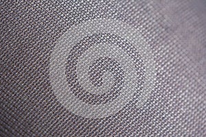 A close up macro portrait of a texture of the threads which form rectangle shaped patterns in the fabric and material of black