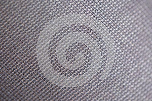 A close up macro portrait of a texture of the threads which form rectangle shaped patterns in the fabric and material of black